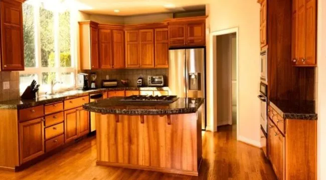 adore able kitchen with shiny oak cabinets