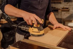 sanding the surfave of kitchen cabinets