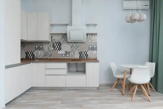 a small, white single-line kitchen